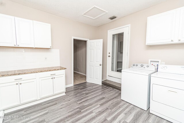 610 S 9th St, Macclenny, FL 32063 - laundry room featuring light wood-style flooring, cabinet space, independent washer and dryer, and visible vents