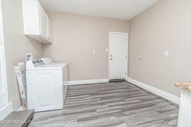 610 S 9th St, Macclenny, FL 32063 - laundry area with cabinet space, light wood-style floors, washer and dryer, and baseboards