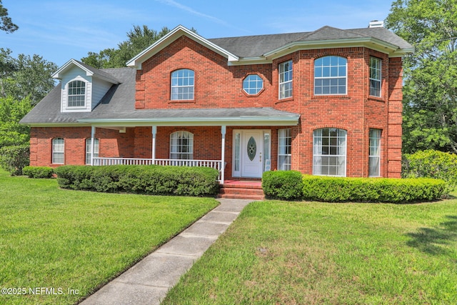 12602 Wimica Ln, Jacksonville, FL 32218 - view of front of house featuring brick siding, a front yard, covered porch, and a shingled roof