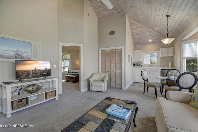 living area featuring carpet floors, high vaulted ceiling, wood ceiling, and baseboards