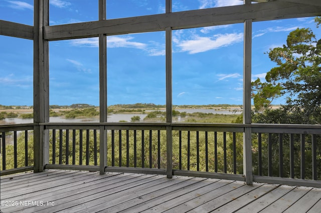 unfurnished sunroom with a water view and healthy amount of natural light