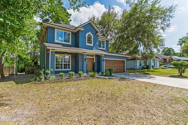 traditional-style home with stucco siding, driveway, a garage, and covered porch