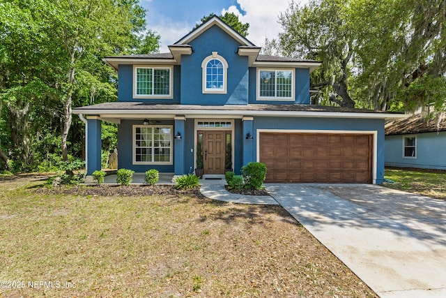 view of front of home featuring stucco siding, driveway, covered porch, and a front yard