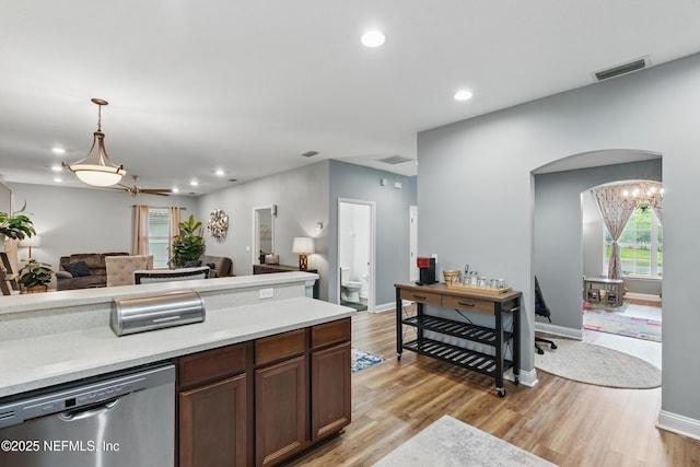 kitchen with dishwasher, open floor plan, light wood-type flooring, light countertops, and recessed lighting
