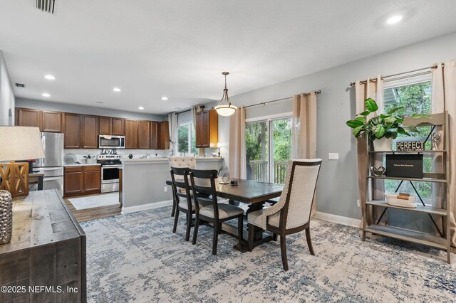 dining area featuring recessed lighting and baseboards