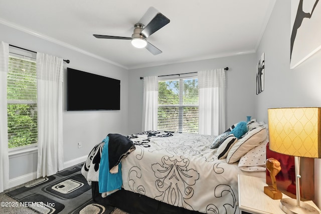 bedroom featuring crown molding, a ceiling fan, baseboards, and carpet flooring