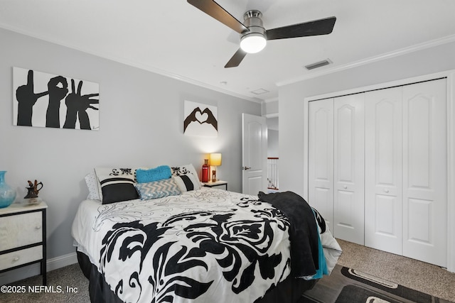 carpeted bedroom with crown molding, a closet, baseboards, and a ceiling fan