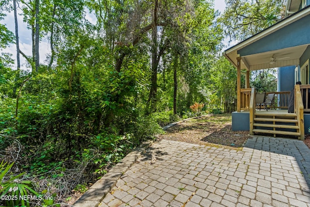 view of patio with a ceiling fan and a deck