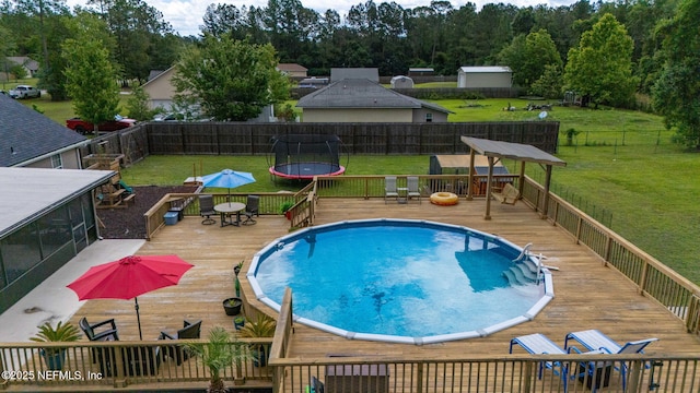 4384 Hickory St, Macclenny, FL 32063 - view of swimming pool with a wooden deck, a trampoline, and outdoor dining area