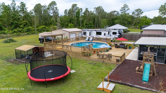 4384 Hickory St, Macclenny, FL 32063 - view of jungle gym featuring a trampoline, a wooden deck, and outdoor dining space