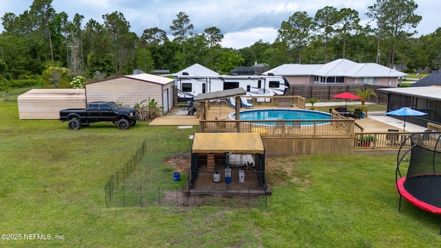 4384 Hickory St, Macclenny, FL 32063 - view of swimming pool with a wooden deck and a trampoline