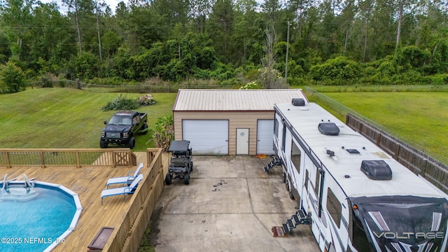 4384 Hickory St, Macclenny, FL 32063 - view of swimming pool with a wooden deck, an outbuilding, and a wooded view