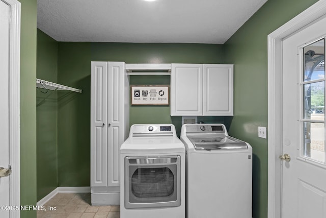 4384 Hickory St, Macclenny, FL 32063 - washroom with washer and clothes dryer, light tile patterned floors, cabinet space, and baseboards