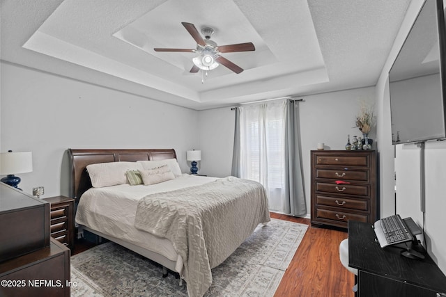 4384 Hickory St, Macclenny, FL 32063 - bedroom with a tray ceiling, wood finished floors, and ceiling fan