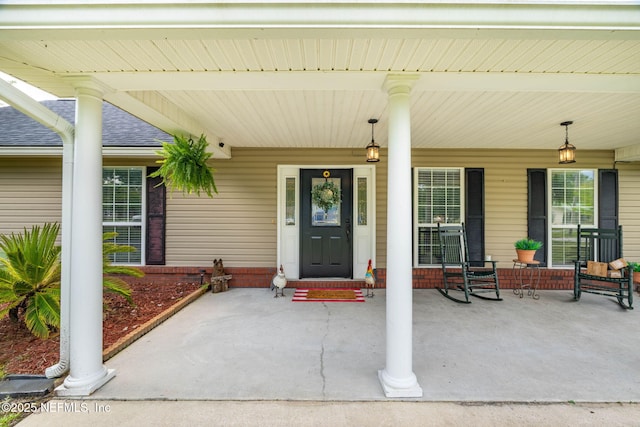 4384 Hickory St, Macclenny, FL 32063 - view of exterior entry featuring roof with shingles and covered porch