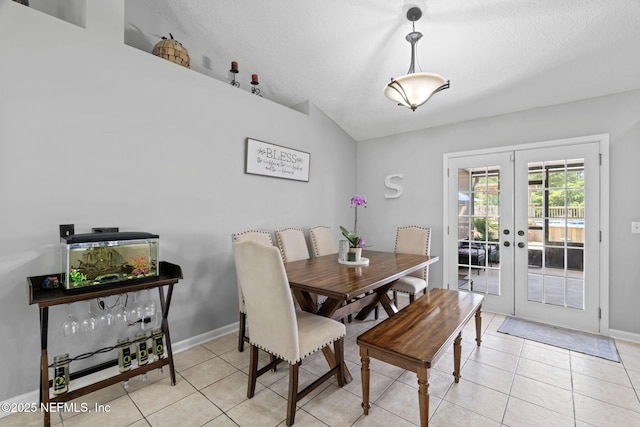 4384 Hickory St, Macclenny, FL 32063 - dining area with french doors, lofted ceiling, light tile patterned floors, baseboards, and a textured ceiling