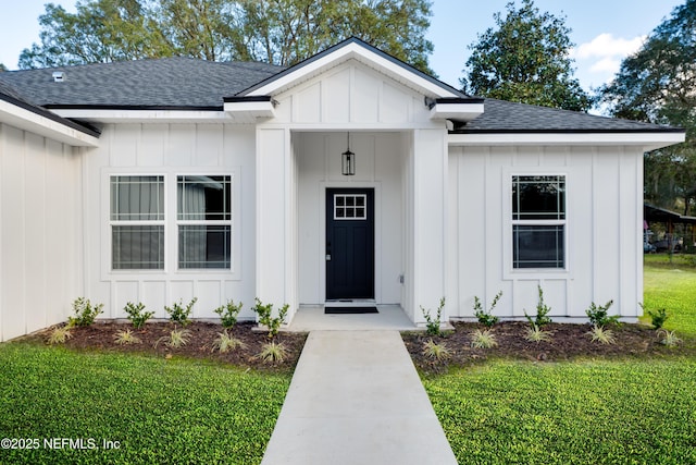 property entrance with board and batten siding and a shingled roof