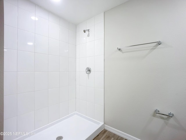 11462 Oakfield Ct, Jacksonville, FL 32258 - bathroom featuring baseboards, wood finished floors, and tiled shower
