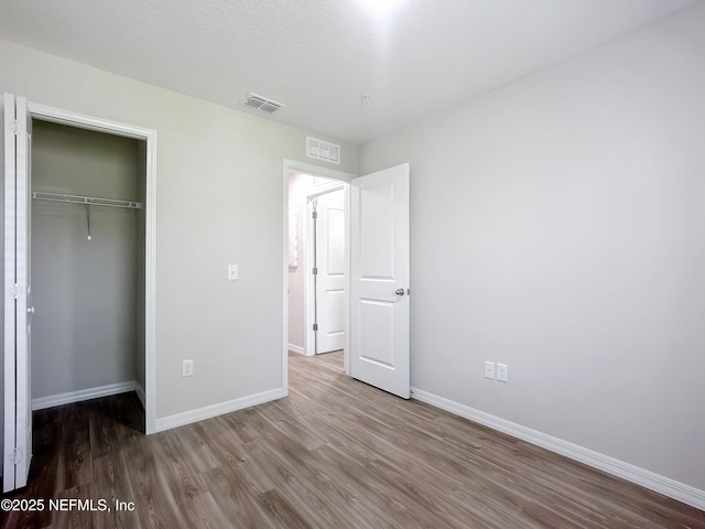 11462 Oakfield Ct, Jacksonville, FL 32258 - unfurnished bedroom featuring a closet, visible vents, wood finished floors, and baseboards