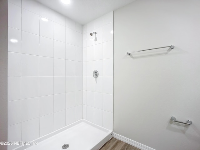 11462 Oakfield Ct, Jacksonville, FL 32258 - bathroom featuring a tile shower, baseboards, and wood finished floors