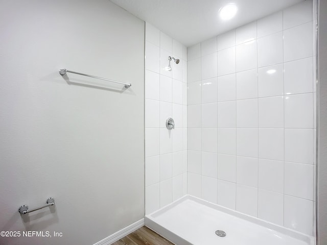 11462 Oakfield Ct, Jacksonville, FL 32258 - bathroom featuring baseboards, wood finished floors, and a tile shower