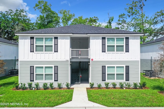 11462 Oakfield Ct, Jacksonville, FL 32258 - view of front of property with a balcony, a front lawn, and board and batten siding