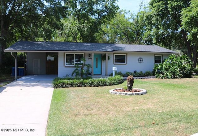 10306 Jolynn Rd, Jacksonville, FL 32225 - single story home with concrete driveway, a carport, and a front yard