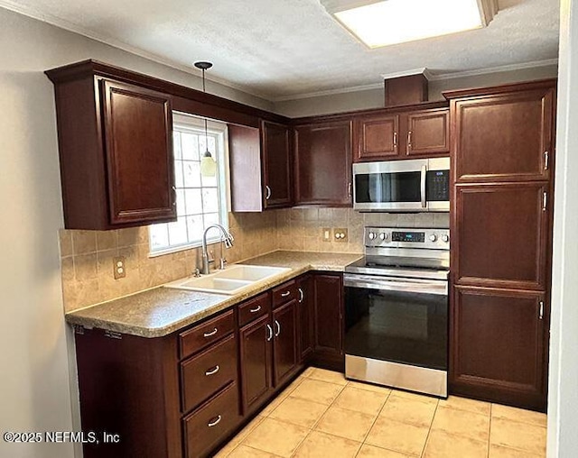 10306 Jolynn Rd, Jacksonville, FL 32225 - kitchen featuring stainless steel appliances, a sink, backsplash, decorative light fixtures, and dark brown cabinets