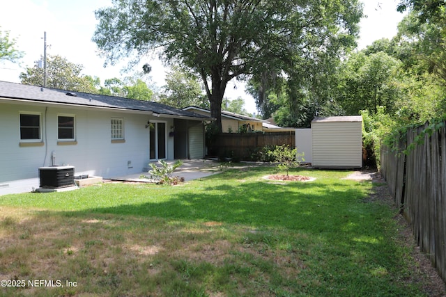 10306 Jolynn Rd, Jacksonville, FL 32225 - view of yard with a shed, central air condition unit, an outbuilding, and a patio