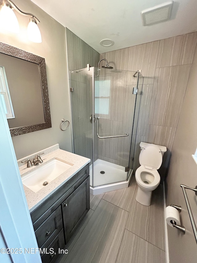 10306 Jolynn Rd, Jacksonville, FL 32225 - bathroom featuring a stall shower, vanity, and toilet