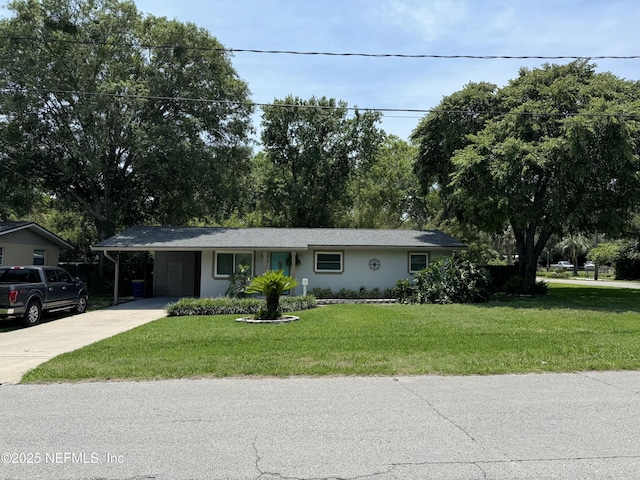10306 Jolynn Rd, Jacksonville, FL 32225 - ranch-style home featuring concrete driveway, an attached carport, and a front yard
