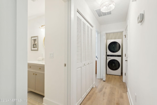 2537 Dauphine Ct E, Ponte Vedra Beach, FL 32082 - laundry area featuring stacked washer and clothes dryer and light wood-style flooring