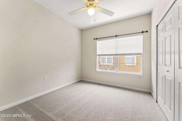 unfurnished bedroom featuring carpet floors, a closet, and baseboards