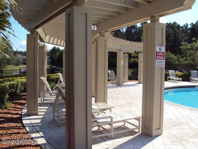 7701 Timberlin Park Blvd Unit 623, Jacksonville, FL 32256 - view of patio / terrace featuring a community pool and a pergola