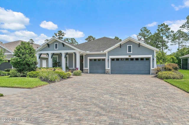 169 Rivercliff Trl, Saint Augustine, FL 32092 - craftsman-style house featuring a garage, decorative driveway, covered porch, a front lawn, and stone siding