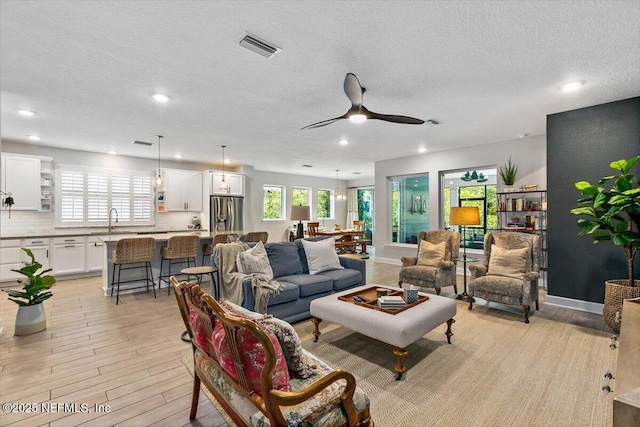 169 Rivercliff Trl, Saint Augustine, FL 32092 - living area featuring healthy amount of natural light, a textured ceiling, recessed lighting, a ceiling fan, and light wood finished floors