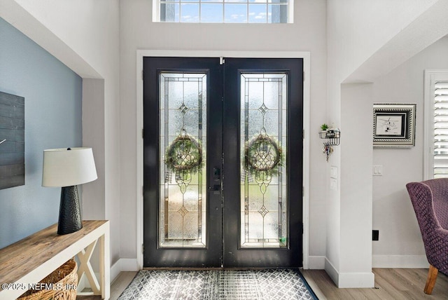11698 Donato Dr, Jacksonville, FL 32226 - entrance foyer featuring french doors, wood finished floors, baseboards, and healthy amount of natural light
