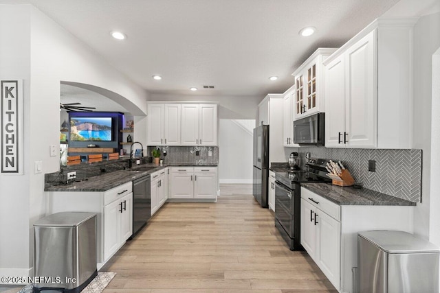 11698 Donato Dr, Jacksonville, FL 32226 - kitchen with black appliances, a sink, light wood-style flooring, white cabinetry, and backsplash