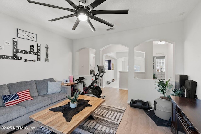 11698 Donato Dr, Jacksonville, FL 32226 - living area with arched walkways, light wood finished floors, and ceiling fan