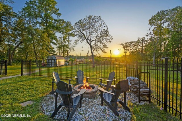11698 Donato Dr, Jacksonville, FL 32226 - view of patio / terrace featuring a fire pit, a storage shed, and an outbuilding