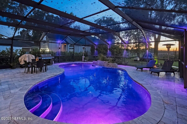 11698 Donato Dr, Jacksonville, FL 32226 - outdoor pool with a patio area, glass enclosure, outdoor dining area, and grilling area