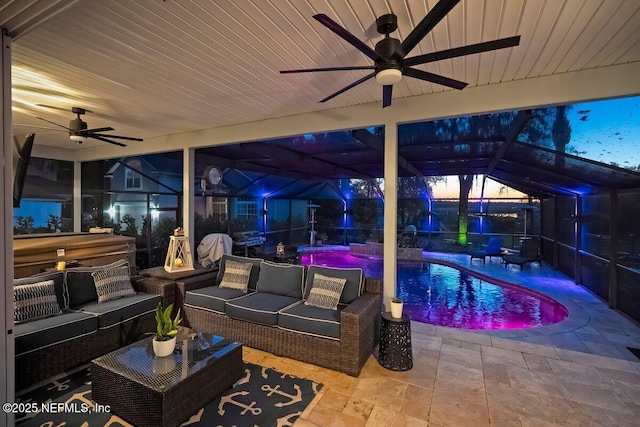 11698 Donato Dr, Jacksonville, FL 32226 - patio at night featuring ceiling fan, an outdoor living space, area for grilling, and an outdoor pool