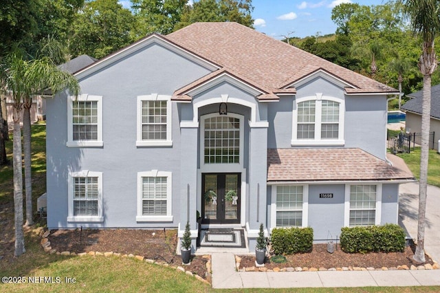 11698 Donato Dr, Jacksonville, FL 32226 - view of front of home with french doors, stucco siding, roof with shingles, and fence
