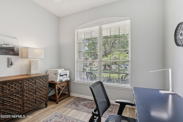 home office featuring baseboards and light wood finished floors