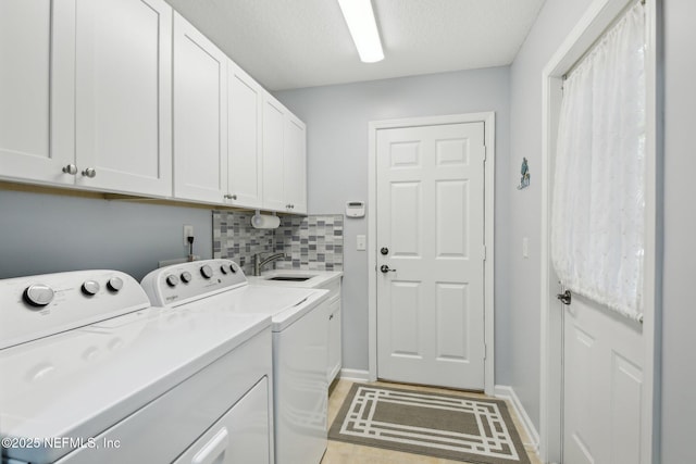washroom featuring cabinet space, independent washer and dryer, and baseboards