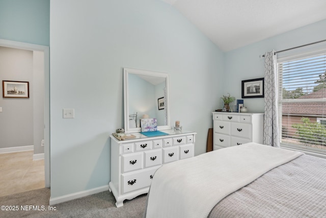 bedroom featuring baseboards, light colored carpet, and high vaulted ceiling
