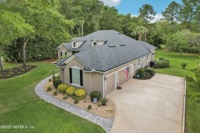 view of front of home with a shingled roof, stucco siding, driveway, an attached garage, and a front yard