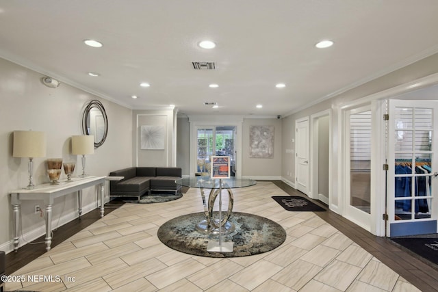 lobby with crown molding and recessed lighting