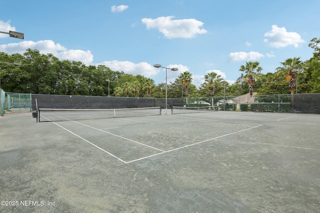 view of tennis court with fence