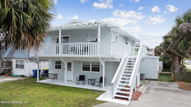 2902 W 5th St, Fernandina Beach, FL 32034 - rear view of house featuring stairway, a patio, and a pergola